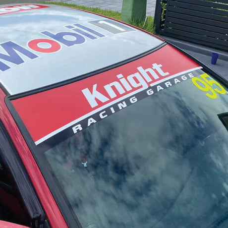 Windscreen banner displaying team name across race car windshield