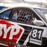 Racing car with 'BYP Racing & Development' and 'Honda' branding, driver visible through a cage.