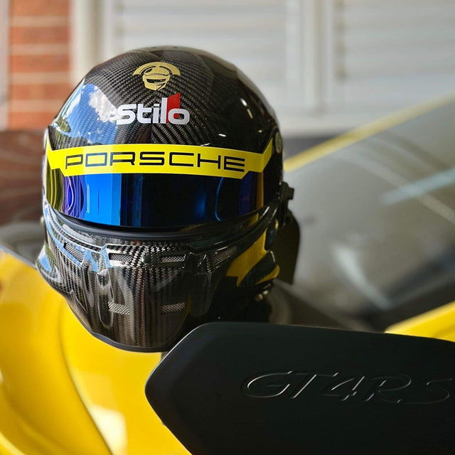 Porsche helmet on a yellow car with 'Stilo' branding